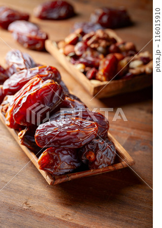 Juicy ripe dates on a wooden table. 116015910
