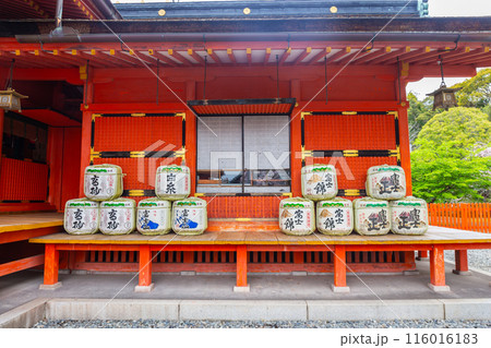 Fujinomiya, Japan April 8, 2024: Sake fermentation tank in Fujisan Hongu Sengen Taisha Shinto Shrine where cherry blossoms are blooming on a rainy day at Shizuoka, Japan. Fujinomiya, Japan April 8, 2024: Sake fermentation tank in Fujisan Hongu Sengen Taisha Shinto Shrine where cherry blossoms are blooming on a rainy day at Shizuoka, Japan. 116016183