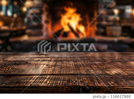 Table background with blurred fireplace. Board template with house interior and fire. Empty rustic wooden desk. Christmas holiday with copyspace Table background with blurred fireplace. Board template with house interior and fire. Empty rustic wooden desk. Christmas holiday with copyspace 116017888