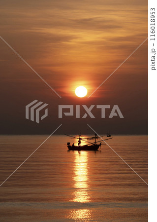 Fishing Wood boat on peaceful calm relaxing on the water and dramatic clouds at Sunset Fishing Wood boat on peaceful calm relaxing on the water and dramatic clouds at Sunset 116018953