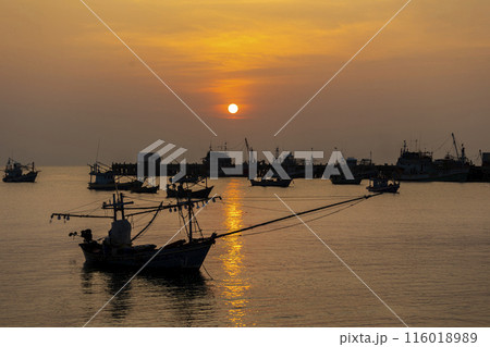 Fishing Wood boat on peaceful calm relaxing on the water and dramatic clouds at Sunset 116018989