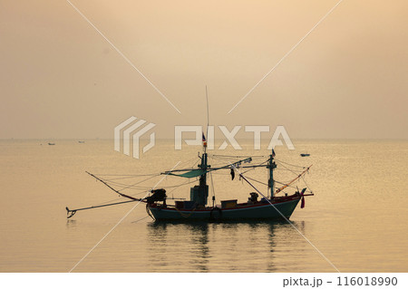 Fishing Wood boat on peaceful calm relaxing on the water and dramatic clouds at Sunset Fishing Wood boat on peaceful calm relaxing on the water and dramatic clouds at Sunset 116018990