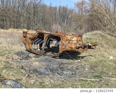 the old car was destroyed in the russian war upside down in forest the old car was destroyed in the russian war upside down in forest 116022544