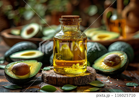 Bottle avocado oil surrounded avocados, rustic wooden background. Sun setting background 116025710
