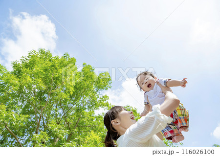 公園で幼児を高く掲げる母親 116026100