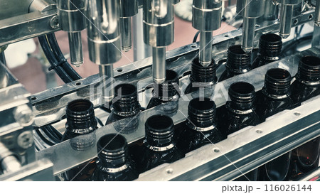 Bottles filling automation machine in modern factory. Technology demonstration of filling and capping bottles in the industry. Inspection of Vials For Defects. Pharmaceutical and drink Manufacturing. Bottles filling automation machine in modern factory. Technology demonstration of filling and capping bottles in the industry. Inspection of Vials For Defects. Pharmaceutical and drink Manufacturing. 116026144