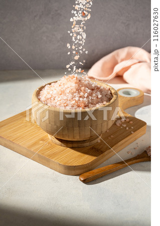 Himalayan pink salt, raw crystals in wooden bowl 116027630