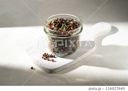 Mixed pepper corn. Black, red and white peppercorns in a glass jar. Mixed pepper corn. Black, red and white peppercorns in a glass jar. 116027640