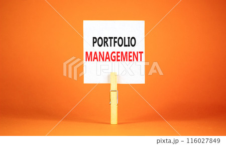 Portfolio management symbol. Concept words Portfolio management on beautiful white paper on wooden clothespin. Beautiful orange background. Business Portfolio management concept. Copy space. 116027849