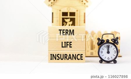 Term life insurance symbol. Concept words Term life insurance on beautiful wooden blocks. Beautiful white table white background. Black alarm clock. Medical term life insurance concept. Copy space. 116027898