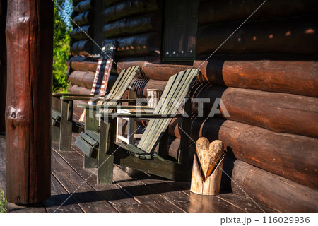 log house terrace and wooden lounge chairs. relax in the fresh air. 116029936