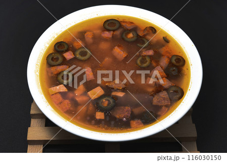 Meat solyanka. Meat soup in a white plate. Meat solyanka. Meat soup in a white plate. 116030150