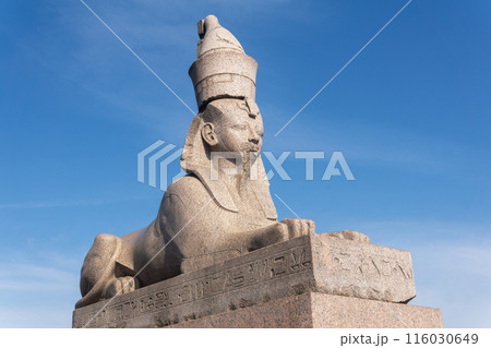 antique statue of the ancient Egyptian sphinx against the sky 116030649