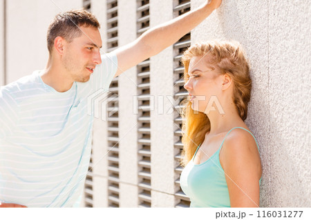 Man flirting with girl on city street 116031277