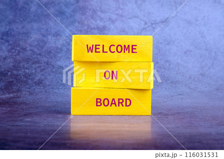 WELCOME ON BOARD on wooden blocks on an abstract bright background 116031531