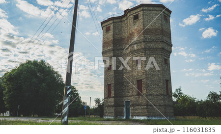 An old brick tower and a nearby power pole An old brick tower and a nearby power pole 116031835
