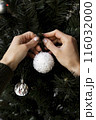 close up hands decorating christmas tree 116032000