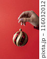 close up hand holding christmas globe 116032012