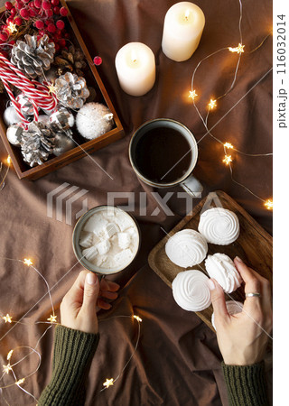 close up hands holding cup and cookie close up hands holding cup and cookie 116032014