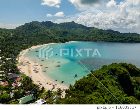 Tropical white sand beach with boats and houses. Diapela Beach in El Nido, Palawan. Philippines. Tropical white sand beach with boats and houses. Diapela Beach in El Nido, Palawan. Philippines. 116035517