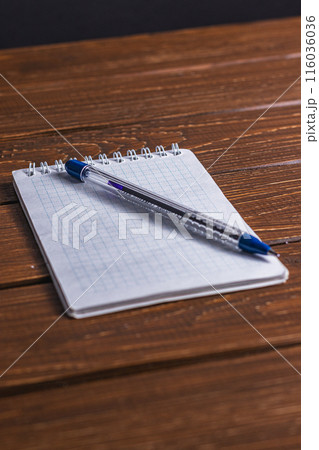 office notebook and pen on a brown table office notebook and pen on a brown table 116036036