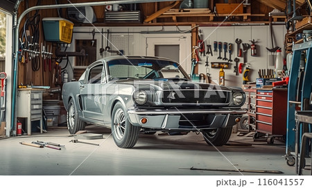 A classic 1960s Ford Mustang is being meticulously restored in a vintage garage filled with nostalgic memorabilia. 116041557