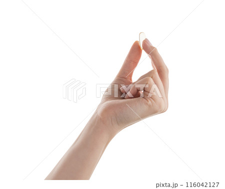 Female hand hold transparent pill isolated on white 116042127