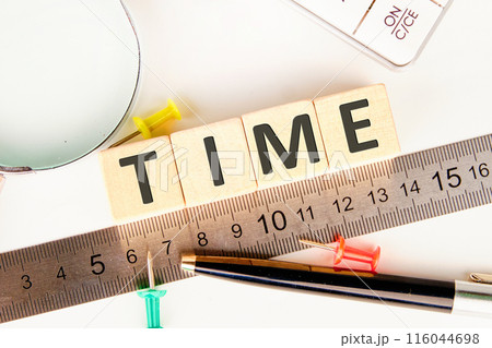 BUSINESS concept. TIME word letters on on wooden cubes laid out along the measuring ruler BUSINESS concept. TIME word letters on on wooden cubes laid out along the measuring ruler 116044698