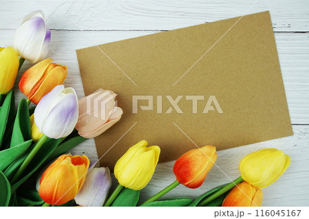Greeting card mockup space for text message decorations with flowers top view on wooden background 116045167