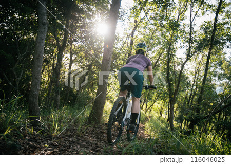 Mountain biking on spring forest trail Mountain biking on spring forest trail 116046025