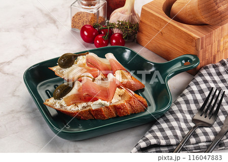 Bruschetta with jamon and caper berries Bruschetta with jamon and caper berries 116047883