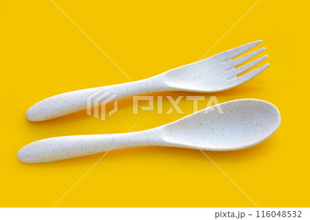 Spoon and fork on yellow background. 116048532