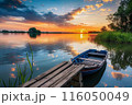 This image shows a serene lake at sunset with a wooden boat docked by a rustic pier, by Generative AI 116050049