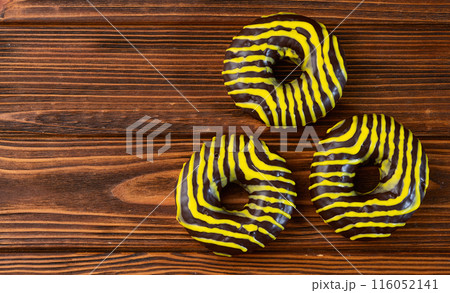 Set of colorful donuts on wooden background Set of colorful donuts on wooden background 116052141