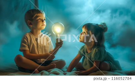 Children hold a glowing lightbulb with a curious expression. The concept of youthful curiosity, bight ideas, and the potential for innovation. 116052784