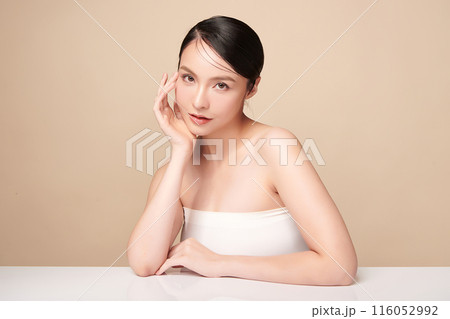 Beautiful young asian woman with clean fresh skin on beige background, Face care, Facial treatment, Cosmetology, beauty and spa, Asian women portrait. Beautiful young asian woman with clean fresh skin on beige background, Face care, Facial treatment, Cosmetology, beauty and spa, Asian women portrait. 116052992