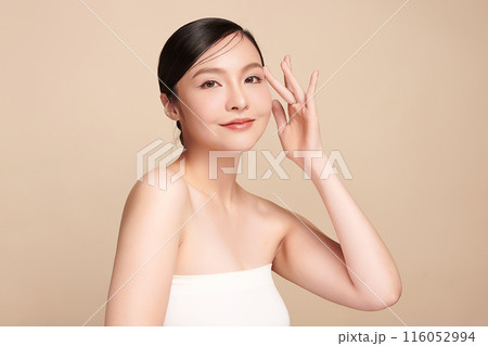 Beautiful young asian woman with clean fresh skin on beige background, Face care, Facial treatment, Cosmetology, beauty and spa, Asian women portrait. 116052994