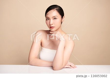 Beautiful young asian woman with clean fresh skin on beige background, Face care, Facial treatment, Cosmetology, beauty and spa, Asian women portrait. Beautiful young asian woman with clean fresh skin on beige background, Face care, Facial treatment, Cosmetology, beauty and spa, Asian women portrait. 116053002