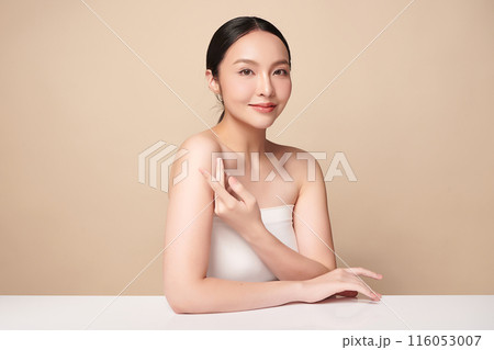 Beautiful young asian woman with clean fresh skin on beige background, Face care, Facial treatment, Cosmetology, beauty and spa, Asian women portrait. 116053007