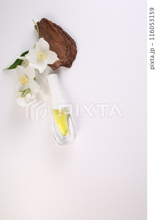 Jasmine essential, bark and Jasmine flowers on white background. Copy space. Flat lay Jasmine essential, bark and Jasmine flowers on white background. Copy space. Flat lay 116053159