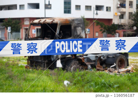 Chinese police tape barricading a burnt truck 116056187