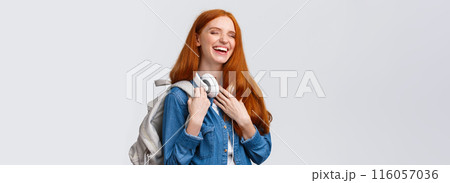 Charismatic and cheerful, lovely friendly redhead girl laughing over girlfriend joke as heading back campus from university classes, having fun chuckle with closed eyes, smiling, holding backpack 116057036