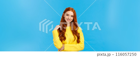 Waist-up shot attractive flirty redhead modern girl millennial in yellow sweater, playing with hair and smiling lovely with entertained, curious expression, looking camera having conversation Waist-up shot attractive flirty redhead modern girl millennial in yellow sweater, playing with hair and smiling lovely with entertained, curious expression, looking camera having conversation 116057250