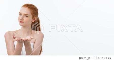 Skin care beauty woman showing empty palm with copy space for product. Excited smiling Caucasian female beauty model isolated on white background. 116057455