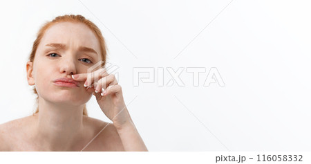 Young caucsian woman squeezes acne on the face of beauty Young caucsian woman squeezes acne on the face of beauty 116058332