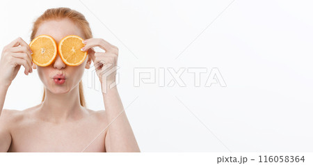 Great food for a healthy lifestyle. Beautiful young shirtless woman holding piece of orange standing against white background. Great food for a healthy lifestyle. Beautiful young shirtless woman holding piece of orange standing against white background. 116058364