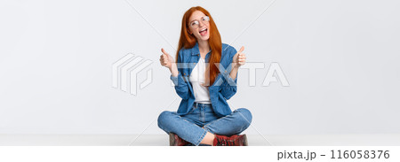 Yeah go for it. Excited and sassy good-looking assertive redhead teenage girl with red foxy haircut, sitting crossed legs on floor, showing thumbs-up and saying yes, recommend, approve something Yeah go for it. Excited and sassy good-looking assertive redhead teenage girl with red foxy haircut, sitting crossed legs on floor, showing thumbs-up and saying yes, recommend, approve something 116058376