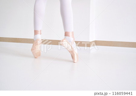 Young ballet girl at studio lesson. Training performance. Stretching exercise Young ballet girl at studio lesson. Training performance. Stretching exercise 116059441