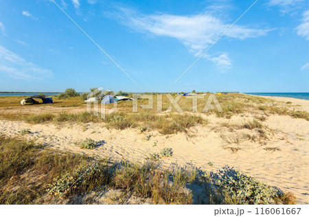 Camping in sandy prairie between lake and sea 116061667