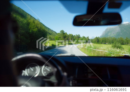 View of the road from inside the car. Traveling by car. View of the road and the panel of the car. View of the road from inside the car. Traveling by car. View of the road and the panel of the car. 116061691